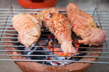Raw pork on clay stove