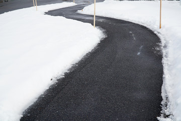 winding sidewalk after snow with snow removed