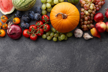 Autumn harvest concept. Seasonal fruits and vegetables on a stone tabletop, top view © kobeza