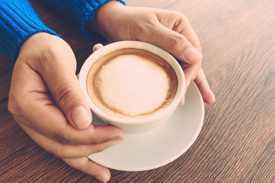 hand holding coffee cup