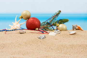 Fototapeta na wymiar Christmas tree decorations on the beach in tropical. Concept of new year holiday in hot countries