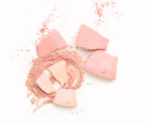 Pink powder cosmetic powder make up crushed on white.