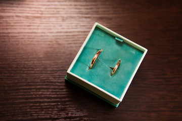 Gold wedding rings on the stand for rings