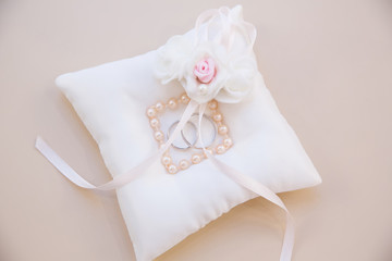 Gold wedding rings on the pillow