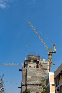 Lifting crane and building in construction site