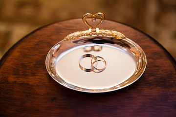 Gold wedding rings on the stand for rings