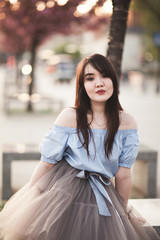 Young Asians girl with modern dress posing in an old Krakow