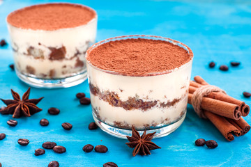 luxurious dessert Tiramisu in a glass on a blue background