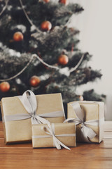 Christmas presents on decorated tree background, holiday concept