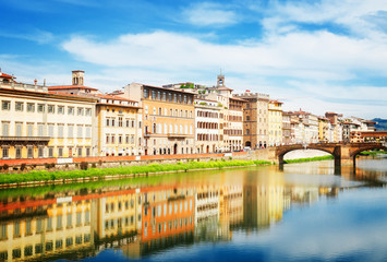 Fototapeta na wymiar old town and river Arno reflecting in water at summer day, Florence, Italy, retro toned