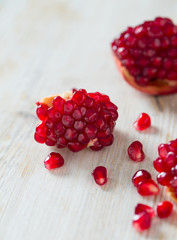 pomegranate seeds on wooden surface