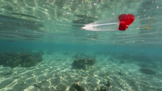 Plastic bottle floating underwater 
