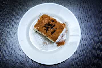 piece of cake on a plate on a dark background