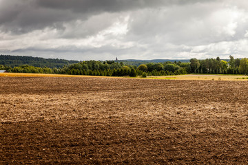 Arable land by the lake, Finland, tonning.Autumn view