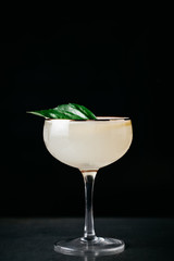 Summer alcoholic cocktail garnished with blood orange and basil
