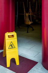 wet floor danger signal at the entrance of a closed restaurant