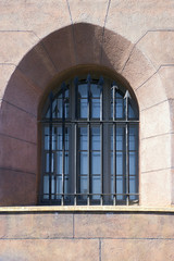 Fototapeta na wymiar Window of the original form with a lattice