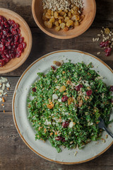 A gourmet salad on rustic surface, vertical, top view