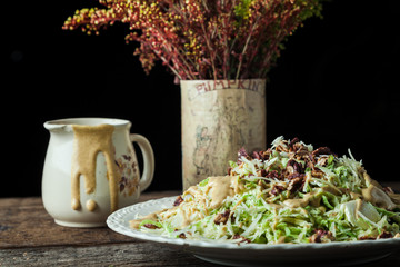Gourmet salad with parmesan on rustic background