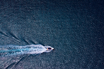 Aerial photograph of boat cruising on calm waters off the coast of Perth, Western Australia.