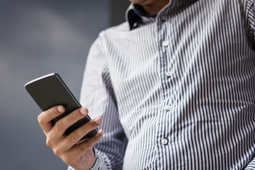 Close up of man using mobile phone.