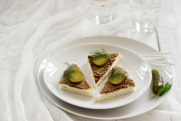 Canape with pate, canned cucumber and dill. Snack. Selective focus.