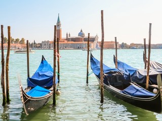 Fototapeta na wymiar Gondolas moored in the Venetian lagoon. Venice, Italy