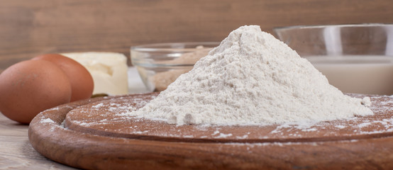 Food ingredients for dough a wooden kitchen board. Cake recipies