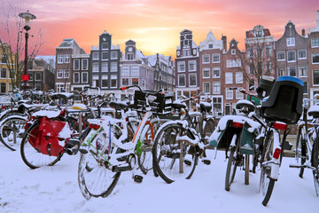 Fototapeta premium Snowy bikes in Amsterdam the Netherlands at sunset