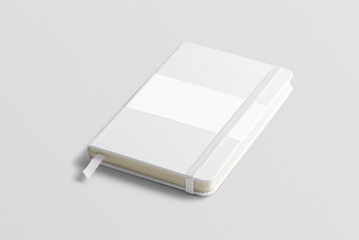 Blank photorealistic notebook mockup on light grey background, front view with label.