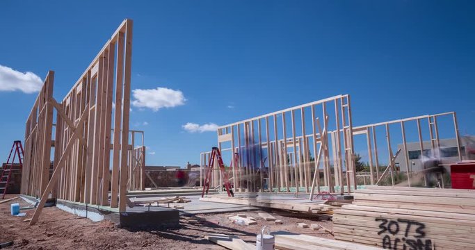 Workers Framing a New Home Construction Time-lapse. a time-lapse of contract workers putting together the frame to a new home construction during the daytime

