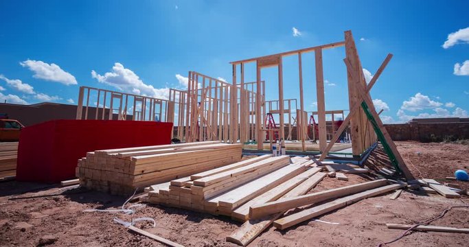 Workers Framing a New Home Construction Wood Pile Time-lapse. a time-lapse of contract workers putting together the frame to a new home construction during the daytime
