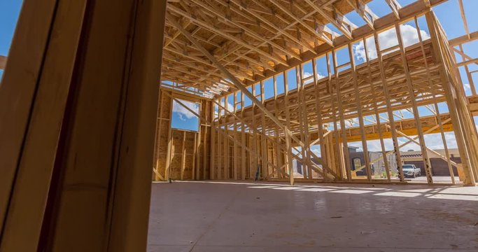 New Construction Framed Home Interior Time-lapse. a time-lapse moves from left to right on the interior of an unfinished new home construction process
