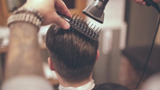 Male hairstyle. Man hair drying in barber shop. Barber styling hair with dryer. Finish hairdressing. Barber hairstyling. Hair dryer man in barbershop. Man hairstyle. Male hair blowing