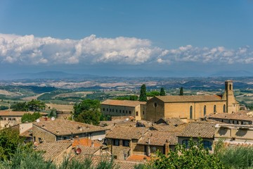 Fototapeta na wymiar View on Tuscany landscape over the roofs of small town