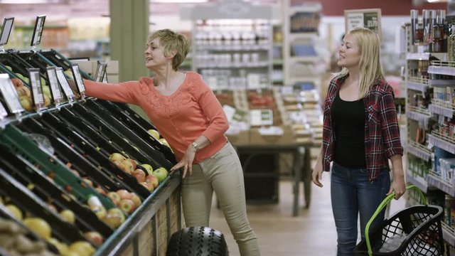  Cheerful mother & daughter shopping together at the grocery store