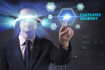Business, Technology, Internet and network concept. Young businessman working in virtual reality glasses sees the inscription: Customer journey