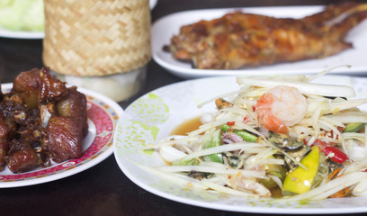 papaya salad.Fried pork.Grilled chicken and fresh vegetable Put on the table, use as a background