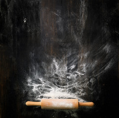 Banner. Baking background with free space for your text. Rolling pin and flour on black table. Copy...