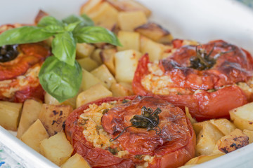 Tomatoes with rice and potatoes.