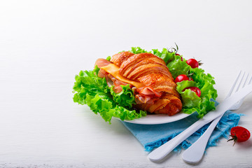 Fresh Croissant Sandwich with  Ham, Cheese,Cherry tomatoes and Salad leaf  Breakfast  Delicious Baking  Light Meal
