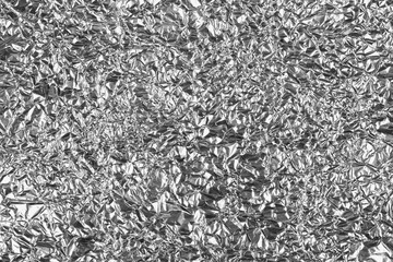Crumpled silver aluminum foil background, abstract texture