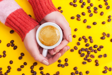 girl's hands holding coffee cup. flat lay, top view