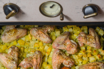 Baked potatoes with wings in the oven