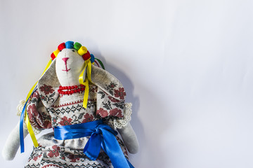 A doll in national Ukrainian in a suit with ribbons.