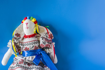 The doll is a guard in a national costume with ribbons.