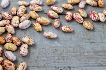 a handful of seeds beans on wooden background