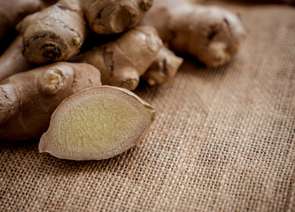Ginger on black table with sack fabric