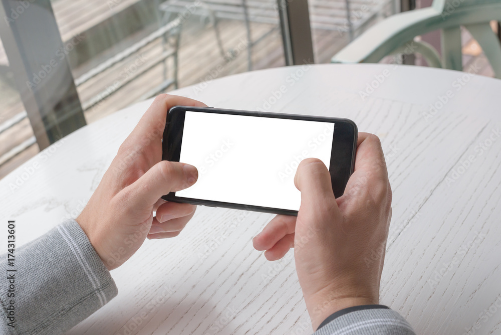 Poster Playing game on smart phone. Closeup view. Mobile phone with isolated screen for app promotion. Horizontal position.