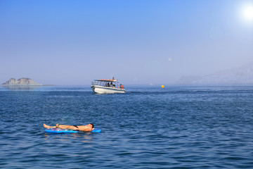 Malowniczy krajobraz zatoki wyspy Rodos i mężczyzny na pontonie.
